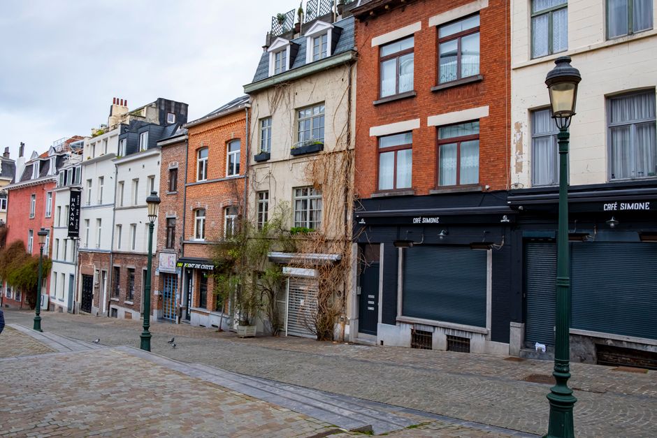 Scenic view of a quiet cobblestone street lined with historic European houses.