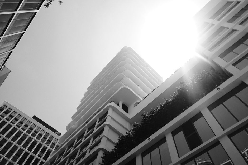 Low-angle view of modern buildings in Tampa, Florida, highlighting geometric design and sunlight streaming through.