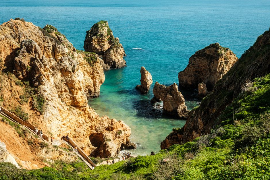 Stunning cliffs and turquoise waters at Ponta da Piedade, popular tourist destination in Algarve, Portugal.