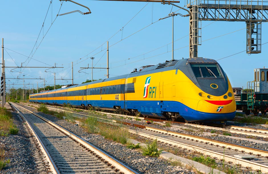 A vibrant high-speed train at Cancello Scalo, Italy, showcasing modern railway infrastructure.