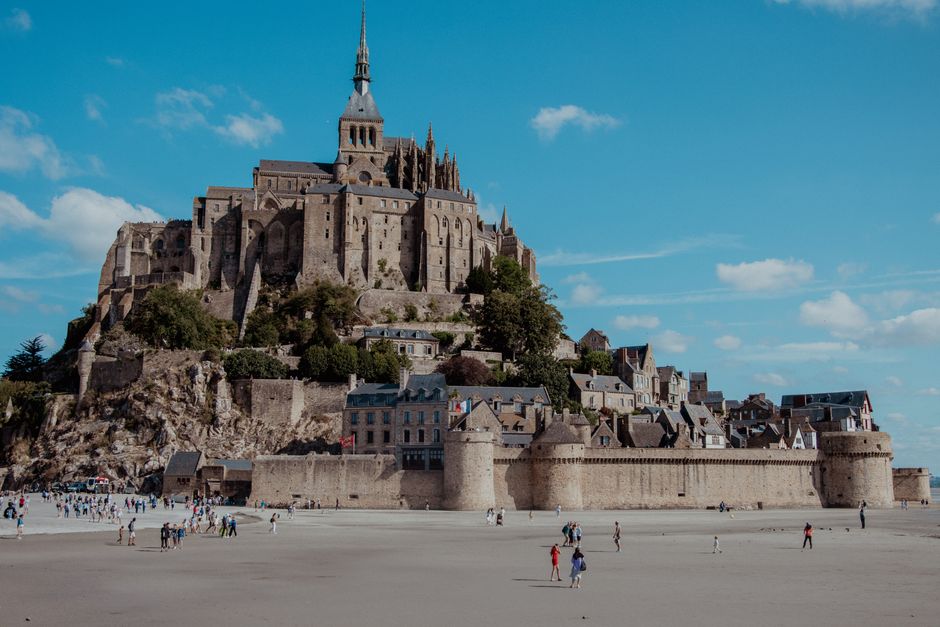 A stunning view of Mont Saint-Michel in Normandy, France, under a clear blue sky.
