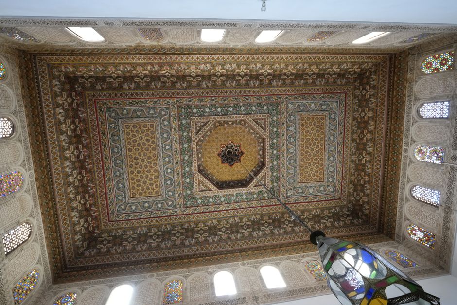 Detailed view of a richly decorated ceiling in Marrakesh showcasing traditional Moroccan design.