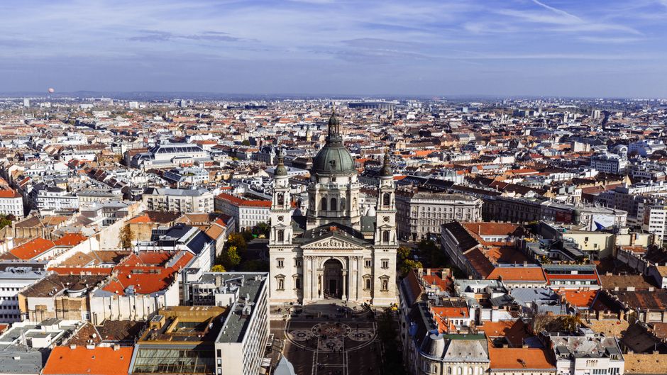 A breathtaking aerial view of St. Stephen's Basilica against the Budapest skyline on a clear day.